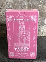 Front of sealed pink Smoostart Ace & Cups holographic tarot box