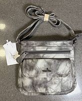 Front of AngelKiss purse showing swirl pattern, front pockets, tags attached