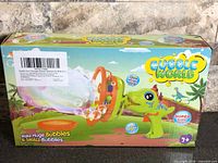 Front of sealed retail box showing Bubble World Dinosaur Bubble Machine graphics