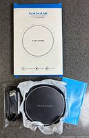 Front of box, charging pad, cable and manual