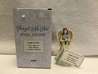 Box front and figurine with tag visible