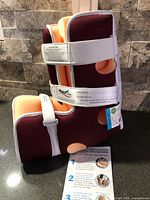 Two Heelift Glide Standard boots with instruction sheet displayed on countertop