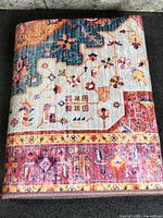 Folded rug showing vibrant multicolour pattern