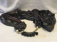 Whole infinity scarf necklace laid out showing fabric pattern and attached bead section