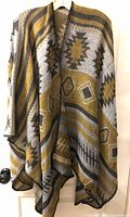 Front view of poncho scarf hanging, showing pattern and drape