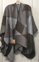 Front view of grey and brown poncho scarf on hanger