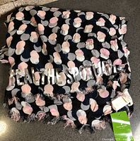 Full view showing dot pattern, slogan and fringe