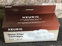 Front of sealed Keurig Water Filter Cartridges box showing brand, product name and six-count indication.