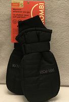 Front view of black Kombi Snowblader mittens with retail tag attached