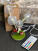 Night light assembled with remote and USB cable beside retail box