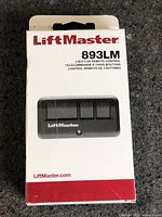 Front of sealed LiftMaster 893LM remote control retail box