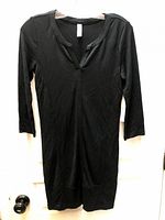 Front view of black Lolë dress hanging