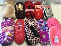 All ten pairs of assorted slippers laid out in two rows