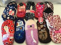 Group shot of all ten slipper pairs showing assorted colours and patterns