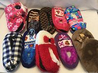 All ten pairs of assorted slippers displayed together