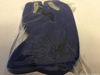 sealed package showing two blue straps coiled