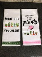 Both packaged tea towels front view