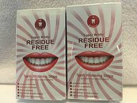 Front view of two sealed Super White Residue Free teeth whitening strip boxes showing graphics and labeling