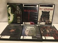 Front view of five DVD cases showing titles Bug, Malignant, Pet Sematary, The Possession of Hannah Grace, Umma, Carrie