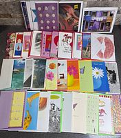All 70 cards and envelopes spread out to show variety of designs