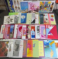 Top-down view of assorted greeting cards showing variety of designs and colours