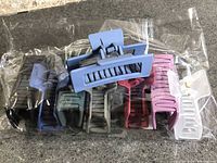 Bag containing eight assorted colour rectangular hair claw clips