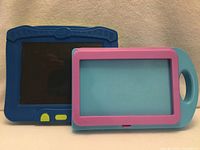 Front view of Crayola drawing board (blue) and Melissa & Doug case (turquoise with pink frame)