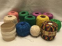 Group of all ten cotton thread balls showing colours and sizes