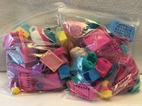 Two clear zipper bags filled with Shopkins plastic accessories