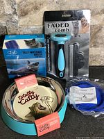 Group shot showing bowl, self-massage brush box, dematting comb package, and collar bag