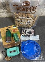 Group shot of all five new dog items including treats, accessories, repeller, bowl, pouch