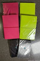 Six sealed small notepads: two pink, two green, two black polka-dot