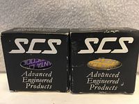 Front view of both SCS boxes side by side showing purple and yellow items through windows
