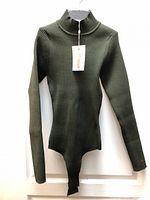 Full view of dark green ribbed bodysuit on hanger with tag attached