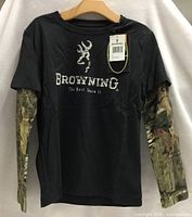 Front view showing logo, tag, and camouflage sleeves
