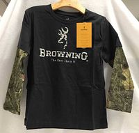 Front view of black Browning shirt with camo sleeves and tag