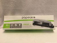 Front of boxed PaperPro inPRESS 12 three-hole punch showing branding and features
