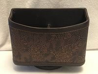 Front view showing floral embossed pattern and overall shape