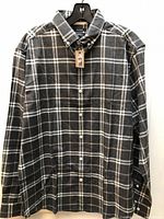 Front view of dark grey plaid RW&CO shirt on hanger showing buttons and tag attached