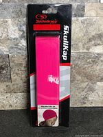 Front view showing packaged pink Sidelines SkullKap
