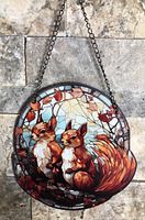 Front view of round squirrels suncatcher hanging