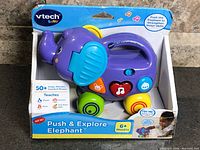 Front of boxed VTech Push & Explore Elephant toy showing main features and age recommendation