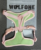 Front view of mint green and pink Wolfone large dog harness on packaging