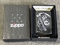 Zippo box opened showing lighter seated in black foam insert