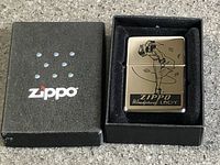 Zippo lighter in open presentation box showing exterior graphic