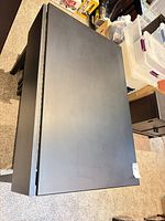 Top view of black laminate table with one leaf down