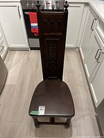 Front view of dark wood cathedral style chair