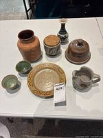 Group shot of all eight ceramic pieces on table