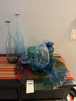 Group view of all seven glass items on dresser