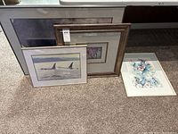 Group shot of four framed artworks leaning together